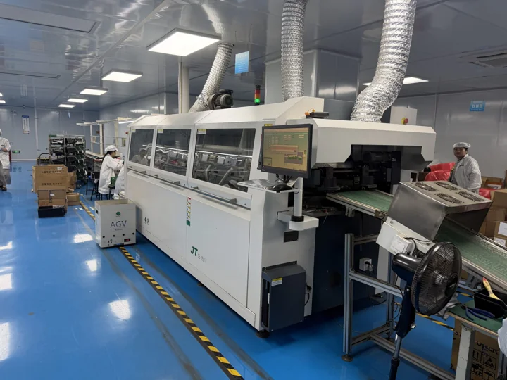 Enclosed wave-soldering equipment with exhaust ducts and a control panel — Shenzhen PCBA factory