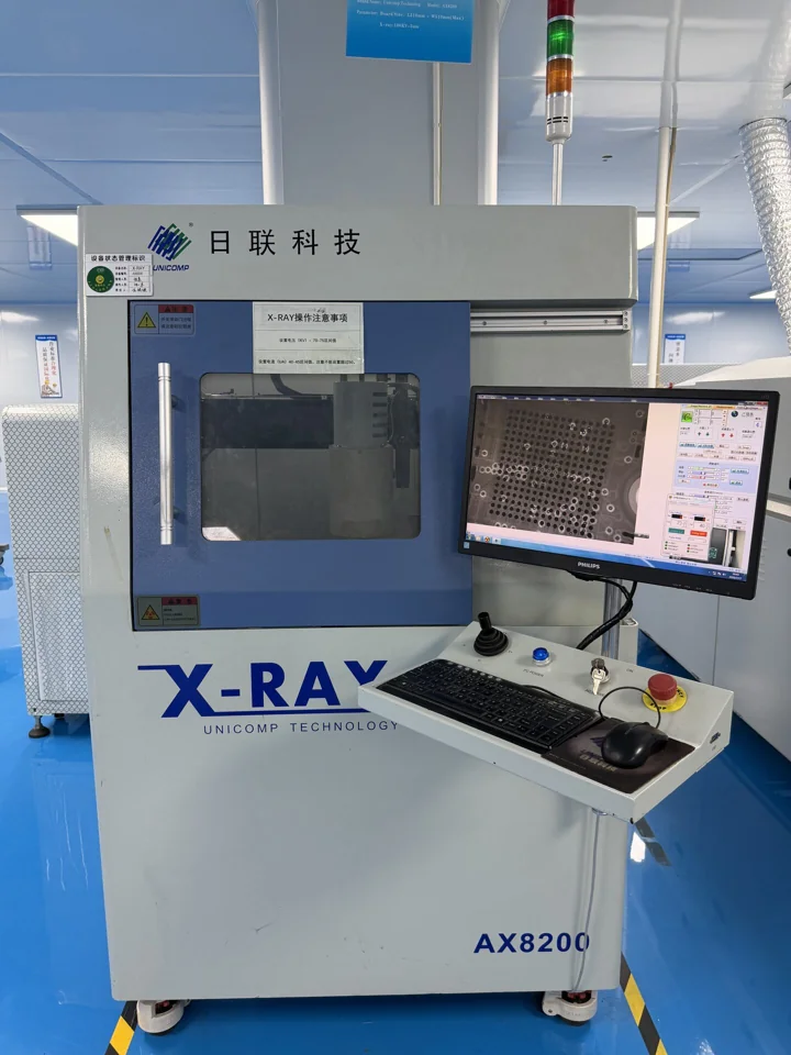 UNICOMP AX8200 X-ray cabinet beside an inspection monitor — Shenzhen PCBA factory