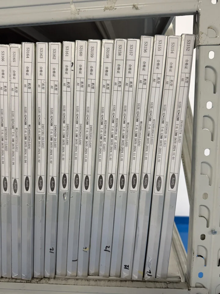 Labeled stencil frames stored upright on a shelf — Shenzhen PCBA factory